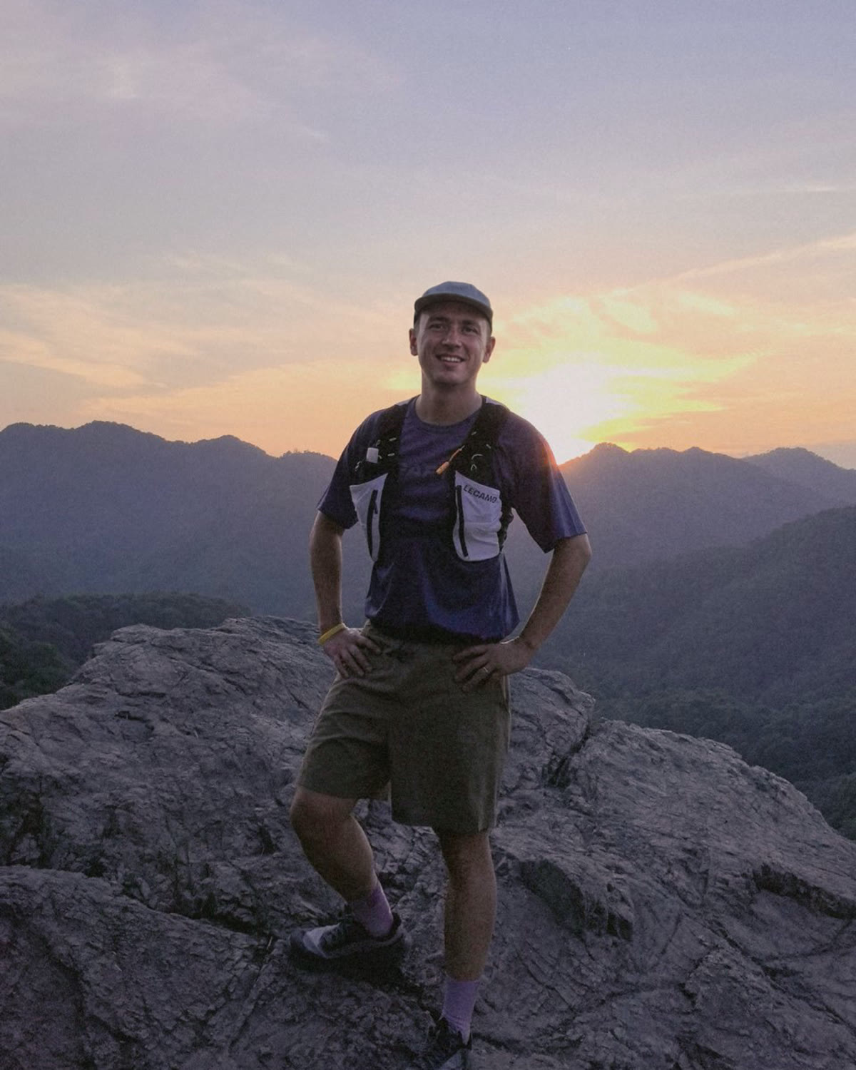 Trail runner wearing a LECAMO vest at mountain sunset