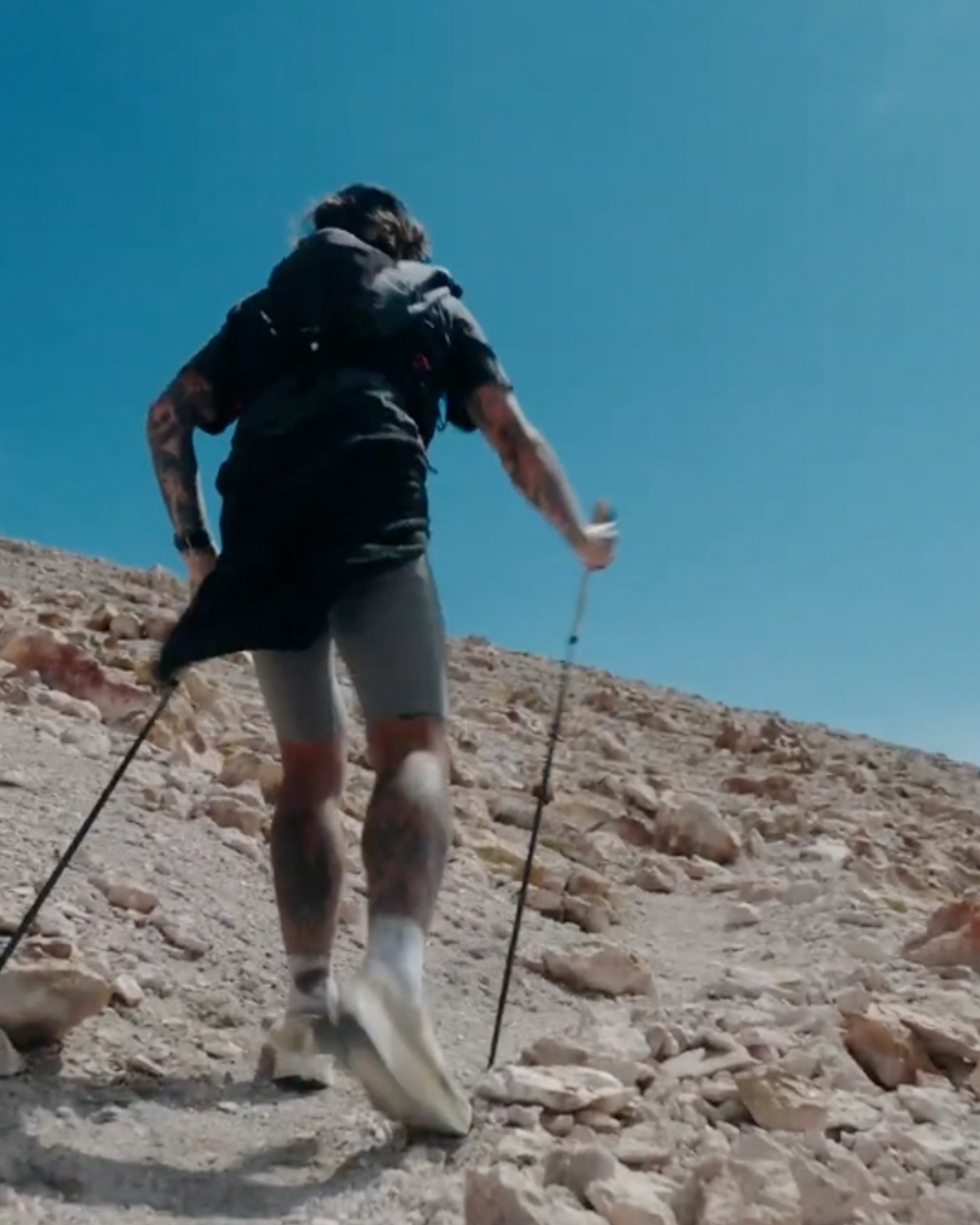 LECAMO runner wearing a trail pack in mountain terrain