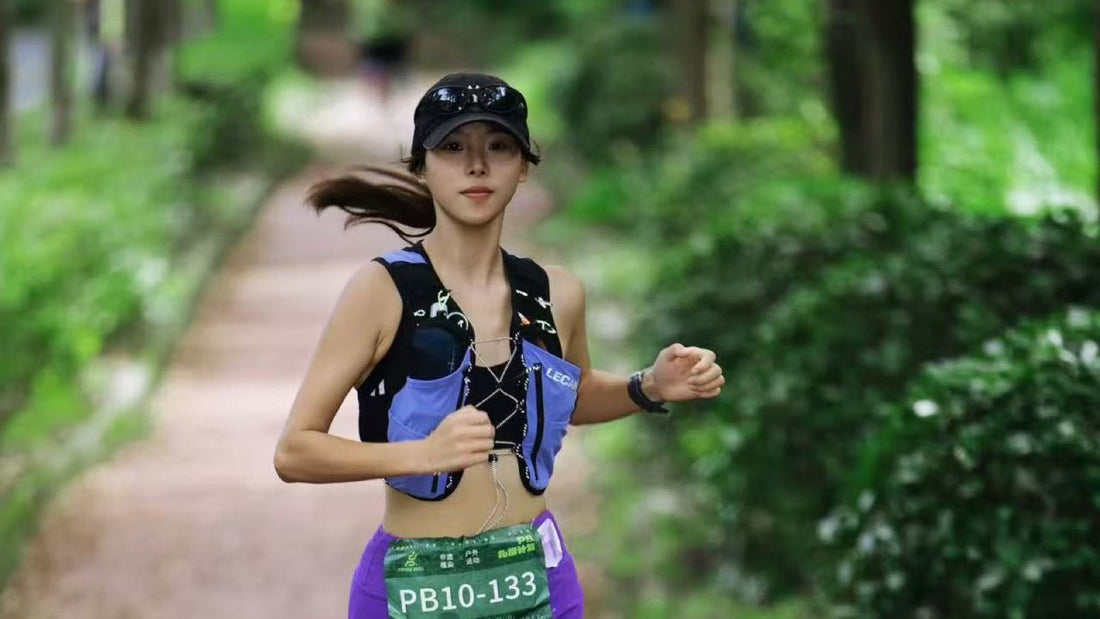 Female trail runner wearing a LECAMO hydration vest on a forest trail