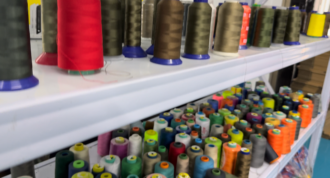 Cones of colored thread arranged on storage shelves