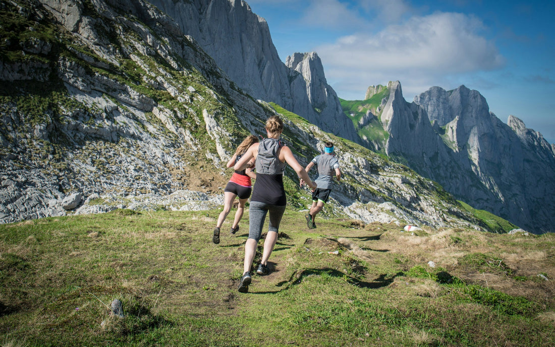 Three runners ascending an Alpine mountain trail in Switzerland