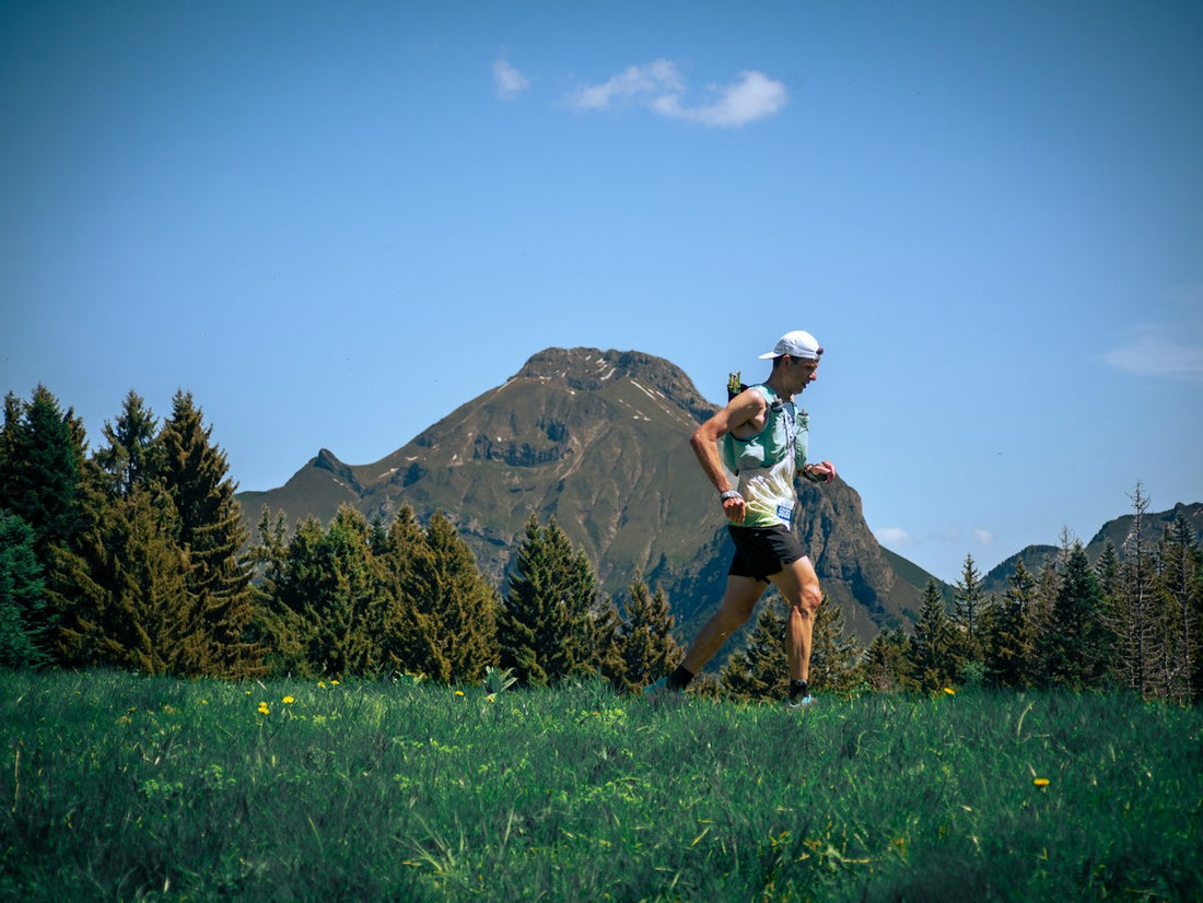 Trail runner wearing a hydration vest in the mountains