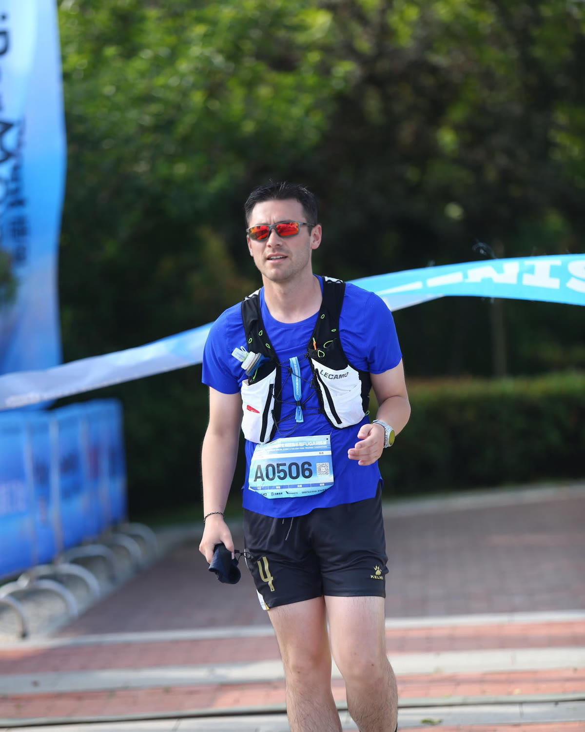 Trail runner wearing a LECAMO hydration vest after a race