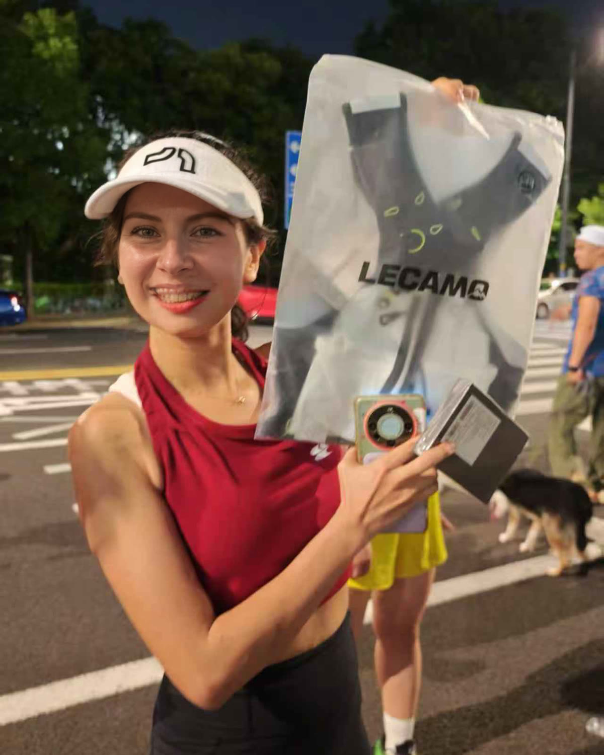 Runner holding a packaged LECAMO hydration vest