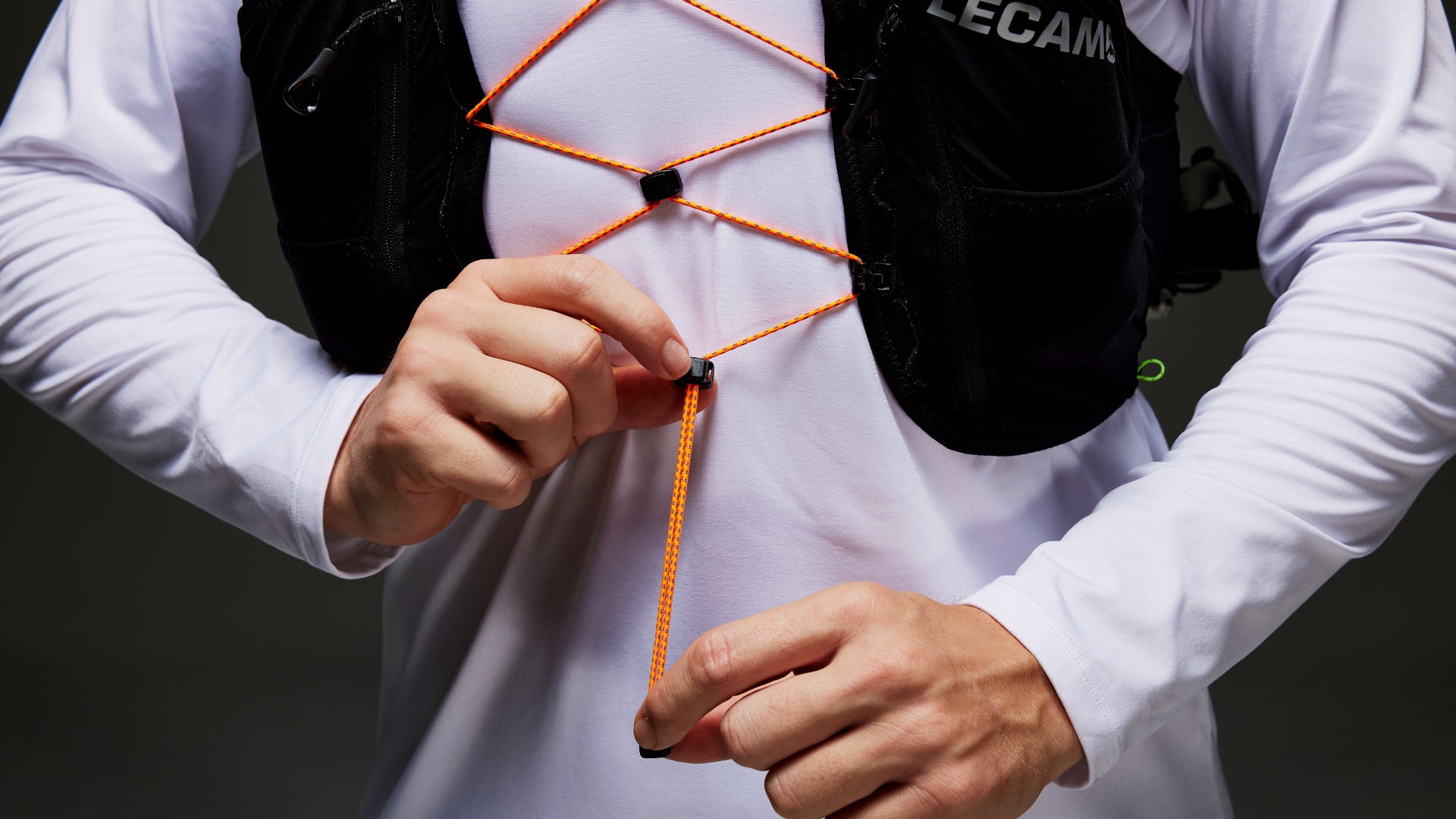 Runner adjusting the front fit of a LECAMO trail pack